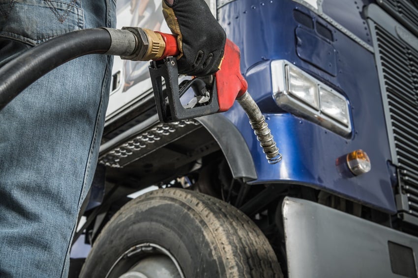 trucker-in-front-of-his-truck-preparing-for-diesel-2022-12-16-11-45-39-utc
